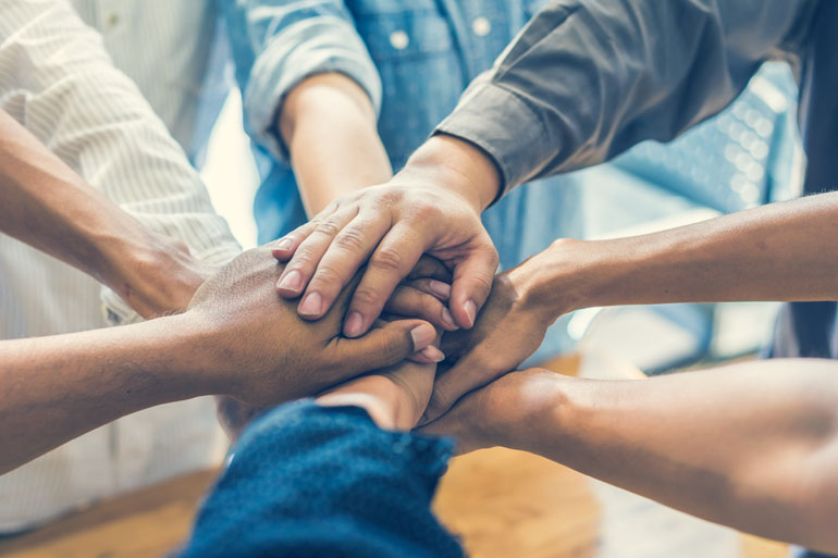 Diverse group of hands together